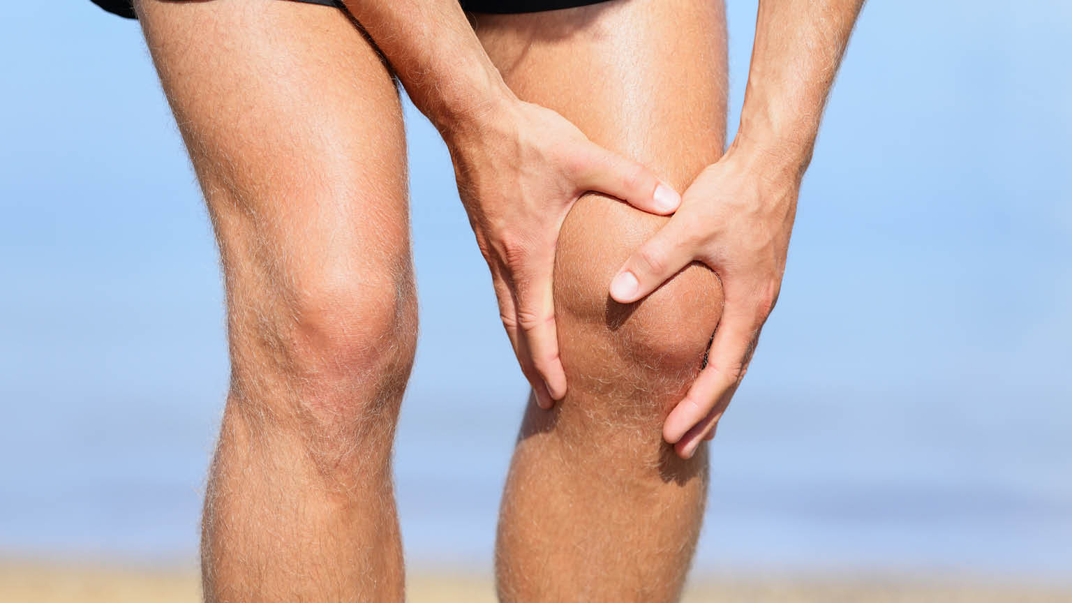 person holding their sore knee