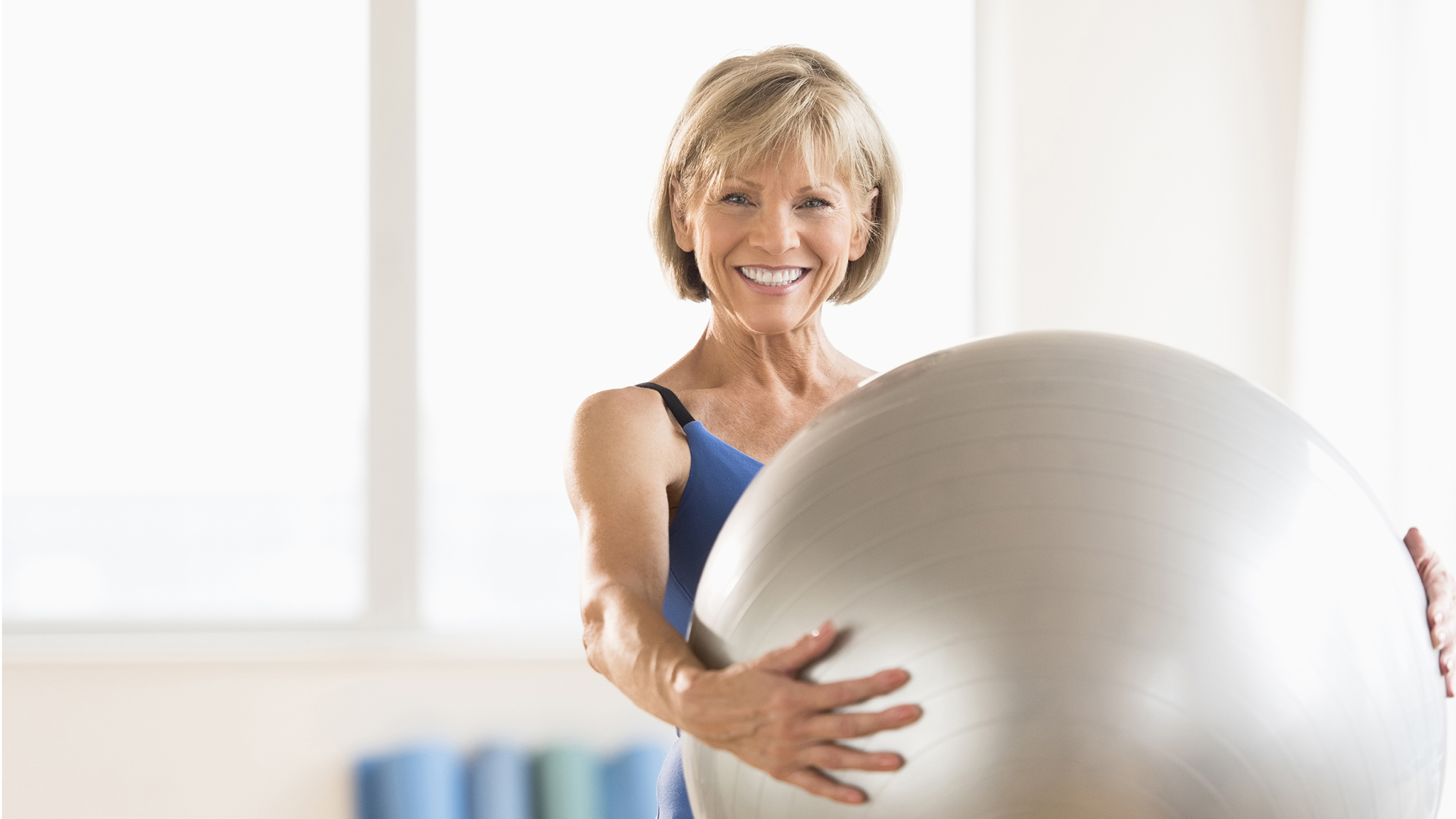 Lady holding a inflated gym ball