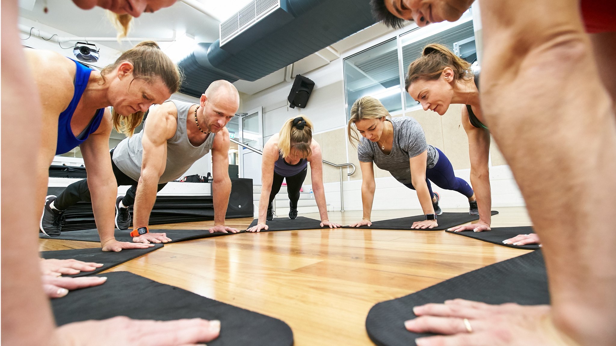group of people in push up position