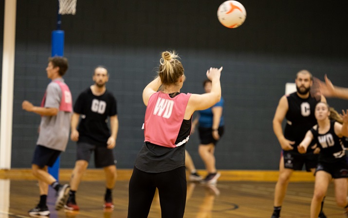 Mixed Netball Rear view of netballer releasing a pass