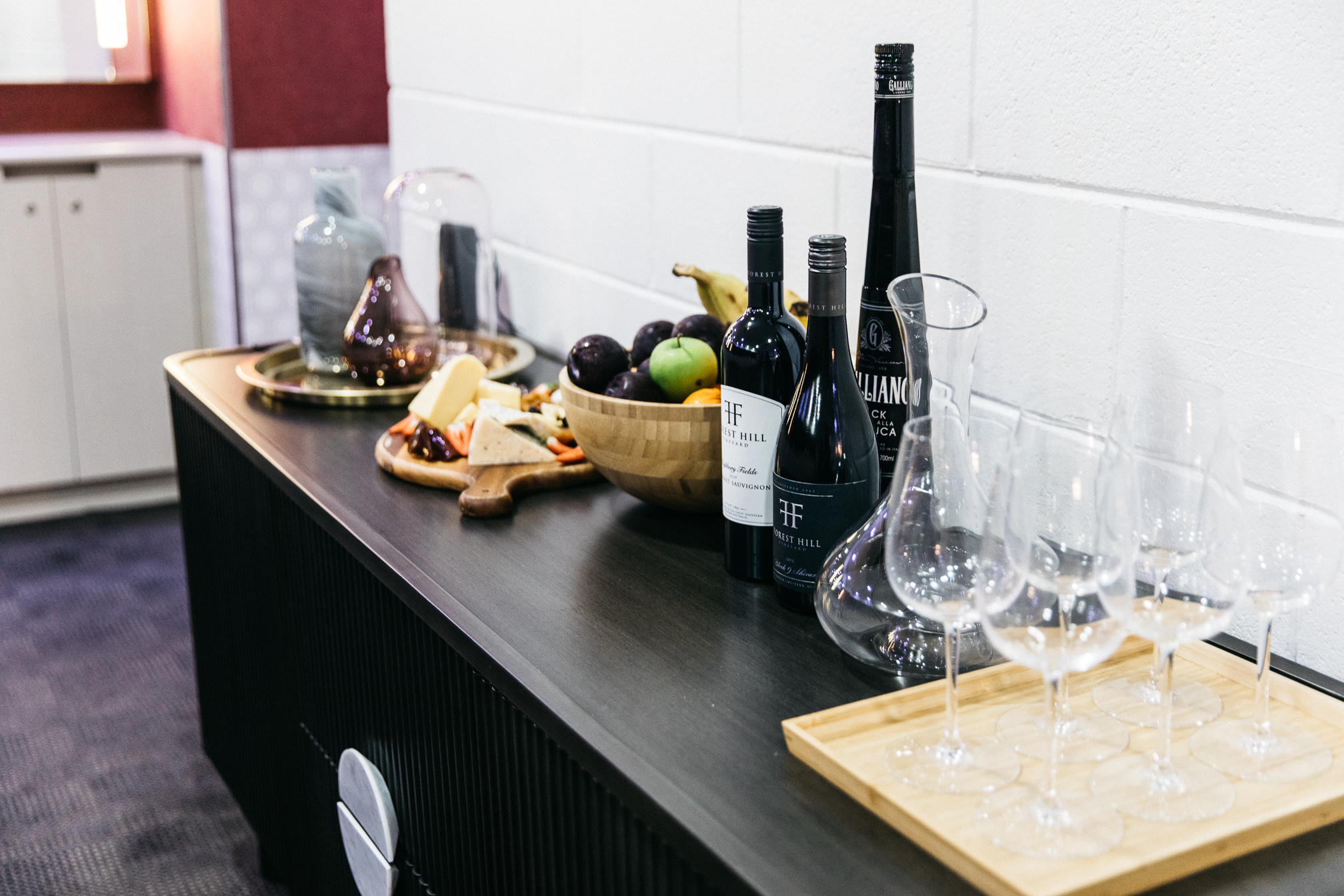 Table with drinks, glasses and food on top
