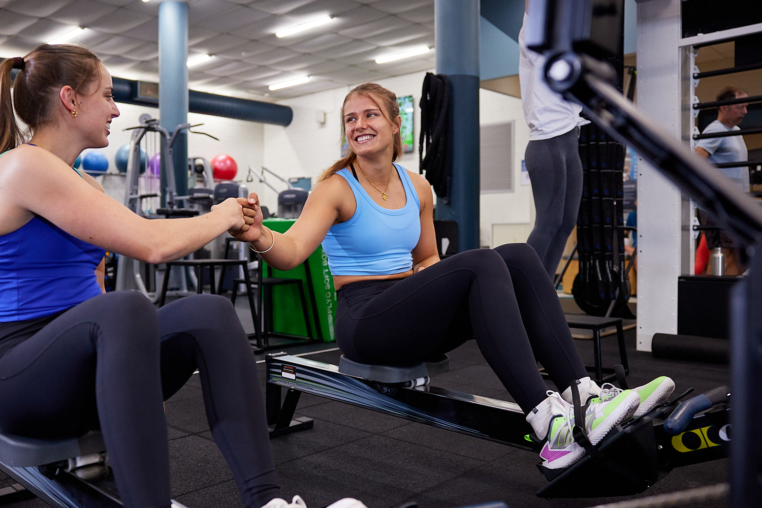Reformer Pilates Members walking through the doors at Perth HPC whilst smiling and chatting