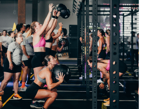 HYROX competitors throwing medicine balls at the HYROX event