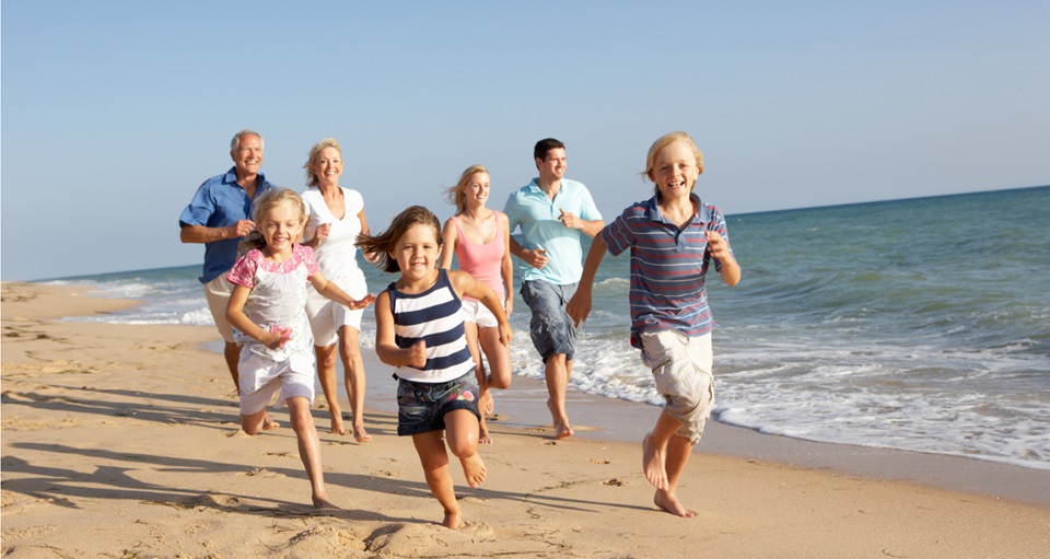 Happy family running on beach