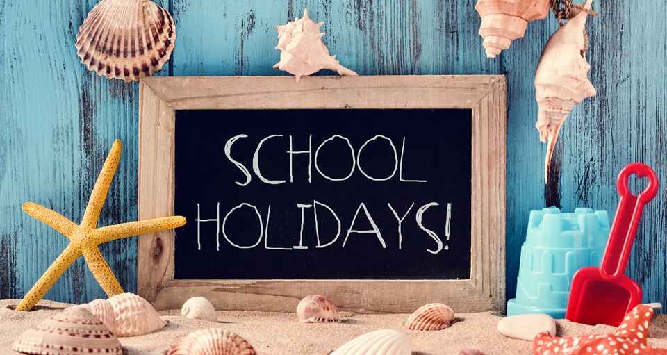school holidays written on a small chalkboard